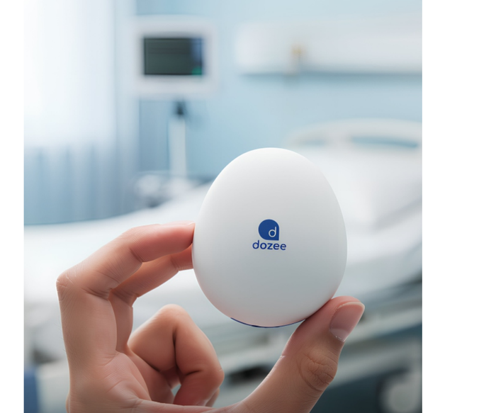 Hand holding the Dozee sensor in a care setting